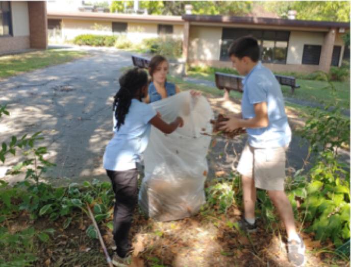 students collecting trash at Shawmut Hills sycamore circle mural site